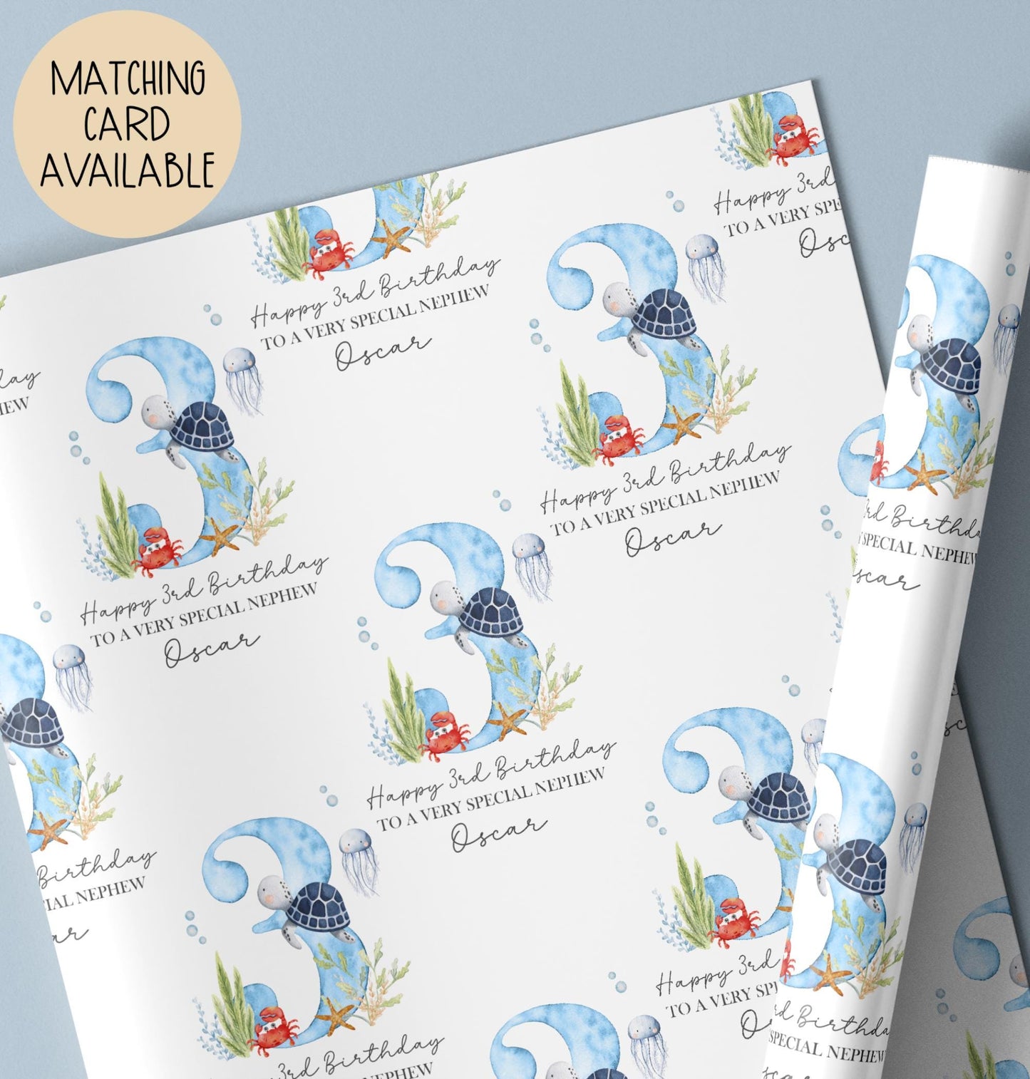 Personalised birthday gift wrap featuring a repeating watercolour design with a large blue number three, turtle, crab, jellyfish and sea plants, with “Happy 3rd Birthday” text and space for a personalised name.