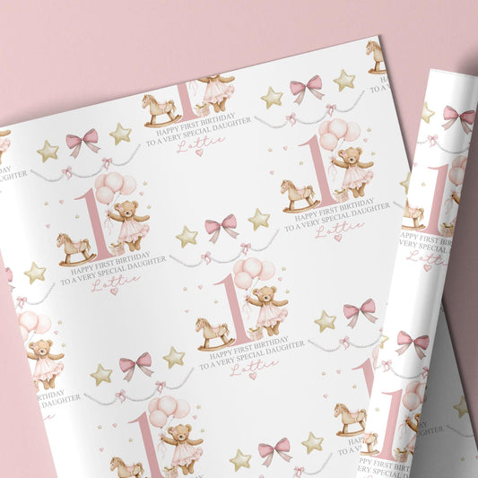 Personalised pink first birthday wrapping paper featuring a cute teddy bear in a tutu holding balloons, rocking horse, gold stars, pink bows, and the number one. Text reads “Happy First Birthday to a Very Special Daughter/Granddaughter/Any relation ” Ideal for baby girl’s first birthday gifts.