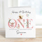 White linen luxury fairy 1st birthday card featuring beautiful little fairies & a pink toadstool & frog prince & the number one in pink & the wording Happy 1st birthday to our special daughter, granddaughter, niece, special little girl, can be adapted to any relation. Personalised with childs name.