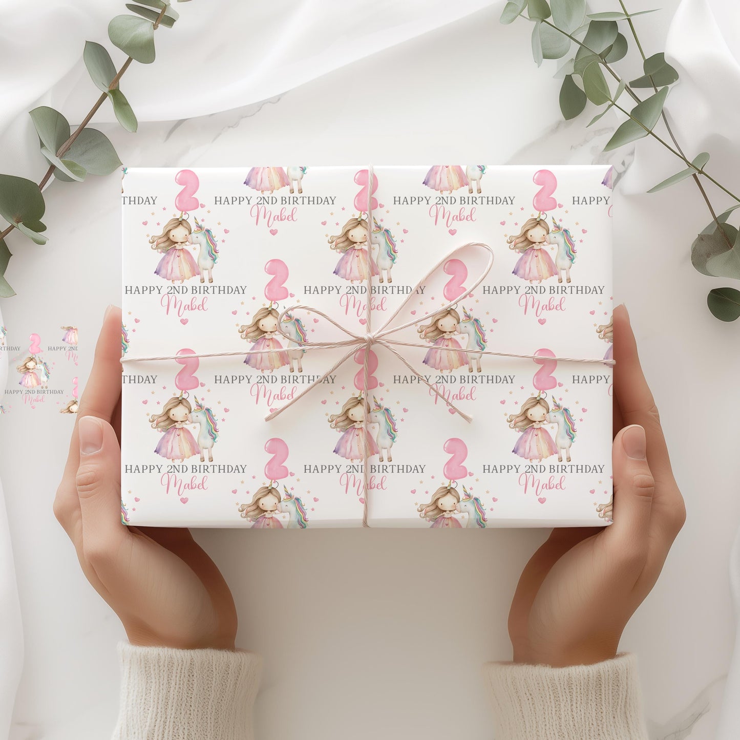 White luxury 1st birthday personalised wrapping paper featuring a gorgeous pastel coloured unicorn & a princess with a number 2 pink balloon and the wording, Happy 1st Birthday personalised with childs name.
