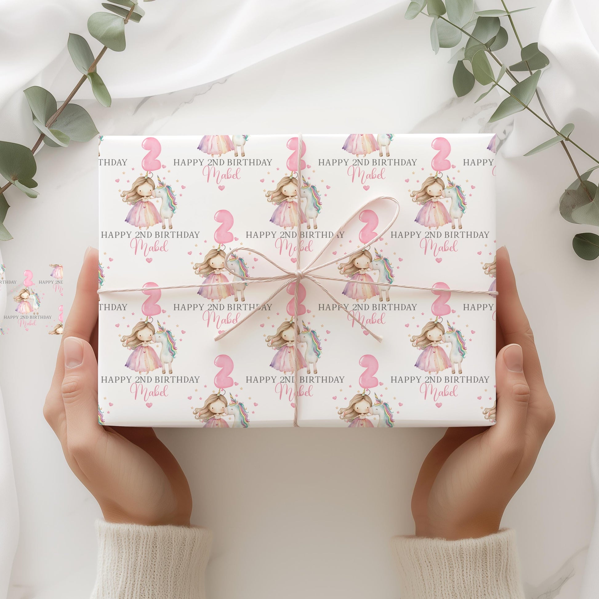 White luxury 1st birthday personalised wrapping paper featuring a gorgeous pastel coloured unicorn & a princess with a number 2 pink balloon and the wording, Happy 1st Birthday personalised with childs name.