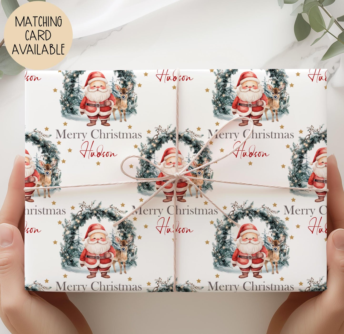 Personalised Christmas gift featuring Santa and a reindeer standing in front of a festive wreath with twinkling lights, gold stars, and the message ‘Merry Christmas Hollie’