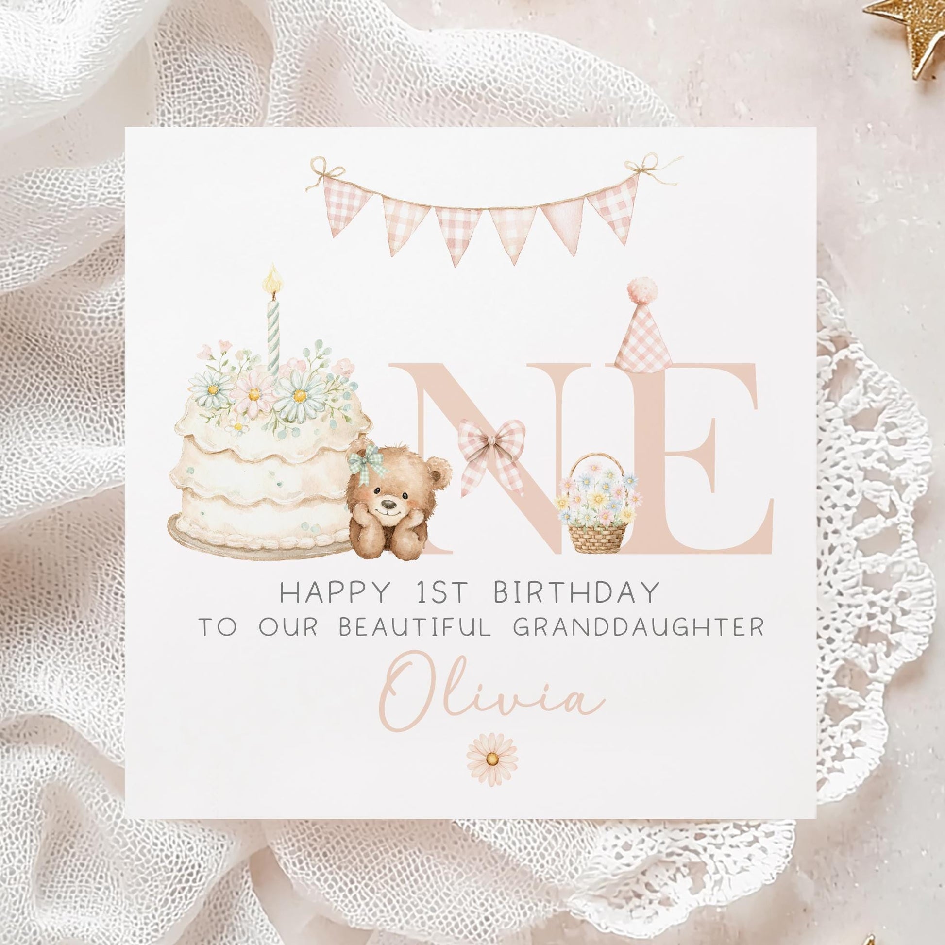 Square personalised first birthday greeting card featuring soft pastel illustrations including a teddy bear, birthday cake with candle, bunting, flowers and a gift basket. The design displays the word ‘ONE’ with decorative details and space for personalised name and relation text.