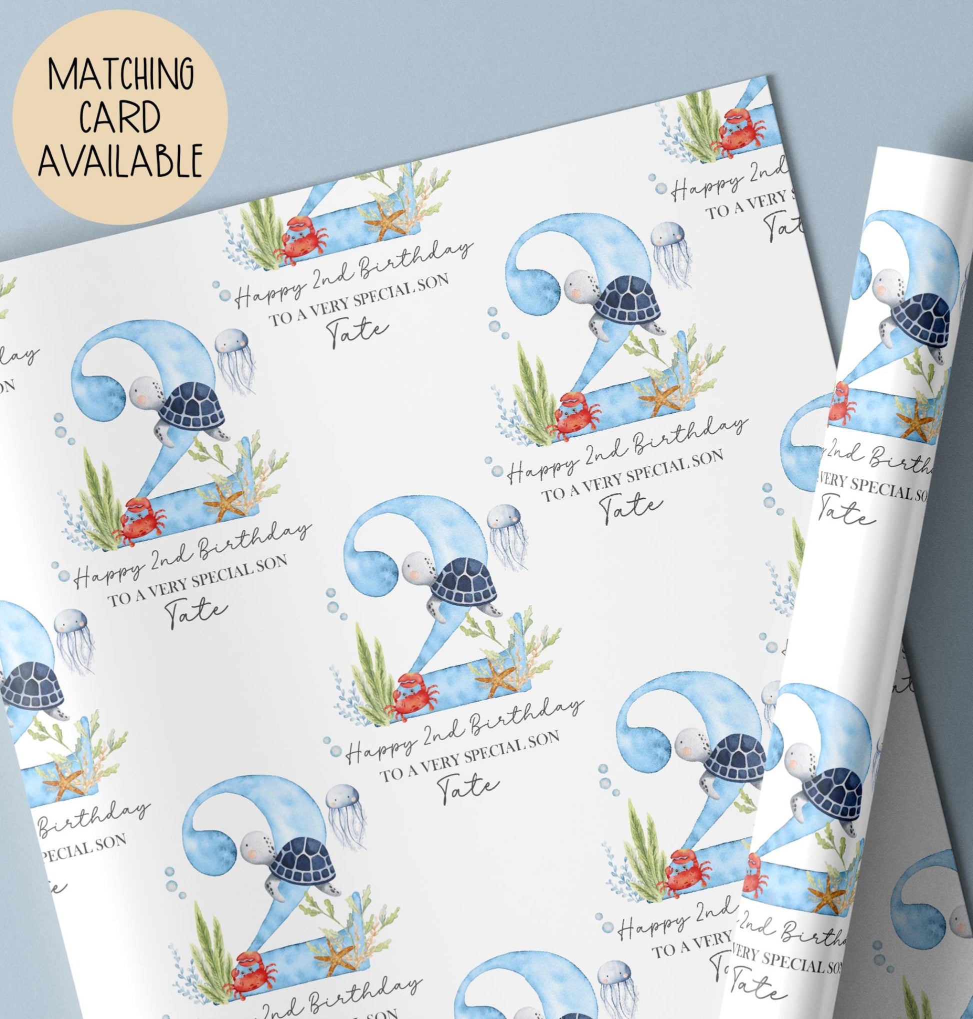 Personalised birthday gift wrap featuring a repeating watercolour design with a large blue number two, turtle, crab, jellyfish and sea plants, with “Happy 2nd Birthday” text and space for a personalised name.