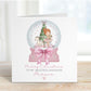 Square personalised Christmas card featuring a ballerina holding a teddy inside a pink snow globe with a Christmas tree, rocking horse, and presents. Text reads “Merry Christmas to our beautiful granddaughter/Daughter/Any relations&quot; Personalised with a name.