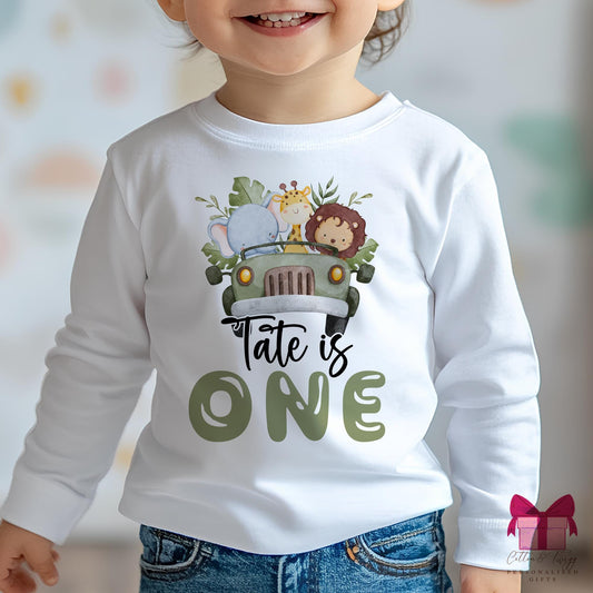 Personalised kidslong sleeved safari birthday t shirt. featuring asafari jeep witha giraffe, lion & elephant & the umber one.