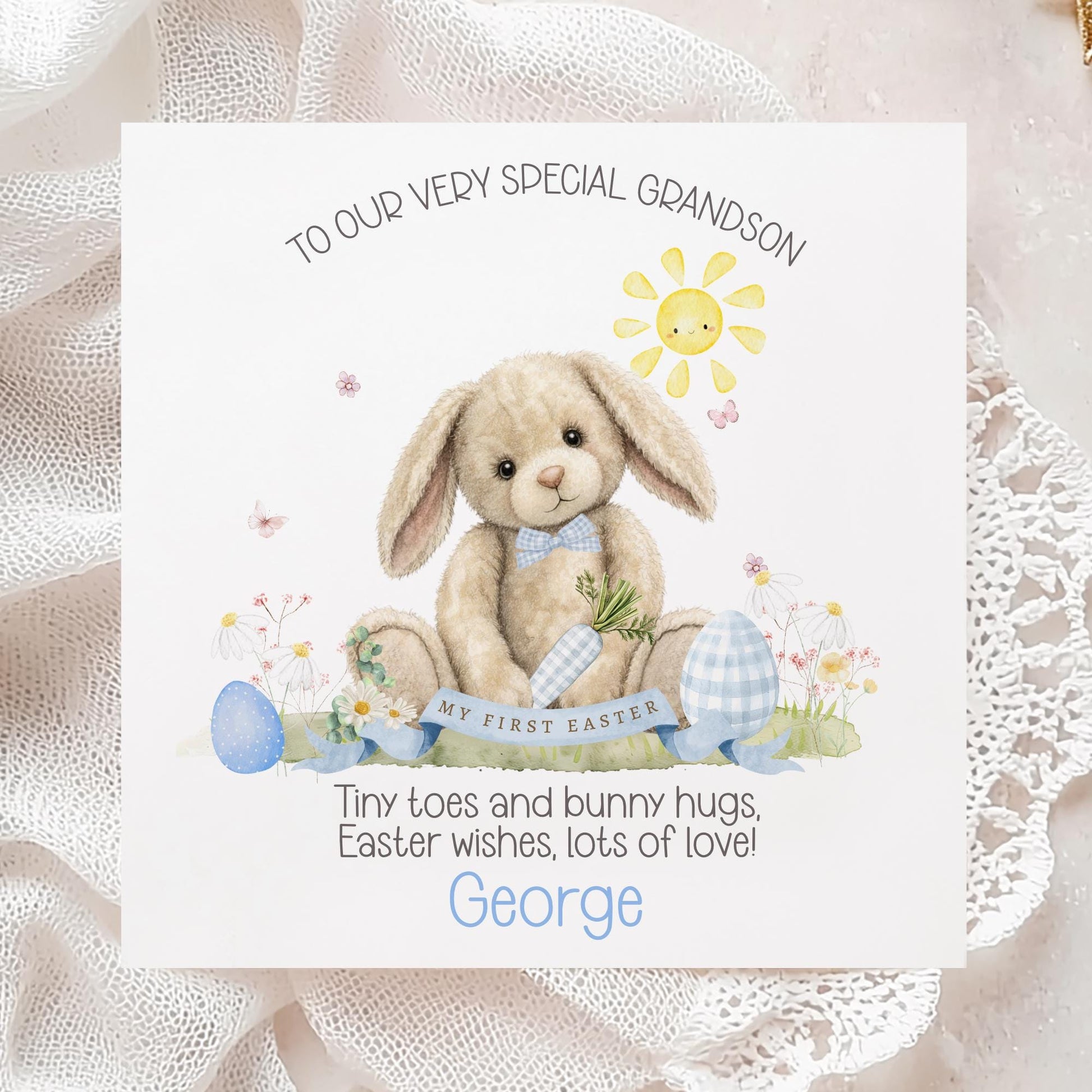 Personalised first Easter card for a grandson featuring a soft illustrated bunny holding a carrot, surrounded by pastel Easter eggs, flowers and a smiling sun, with “My First Easter” banner and space for a personalised name.