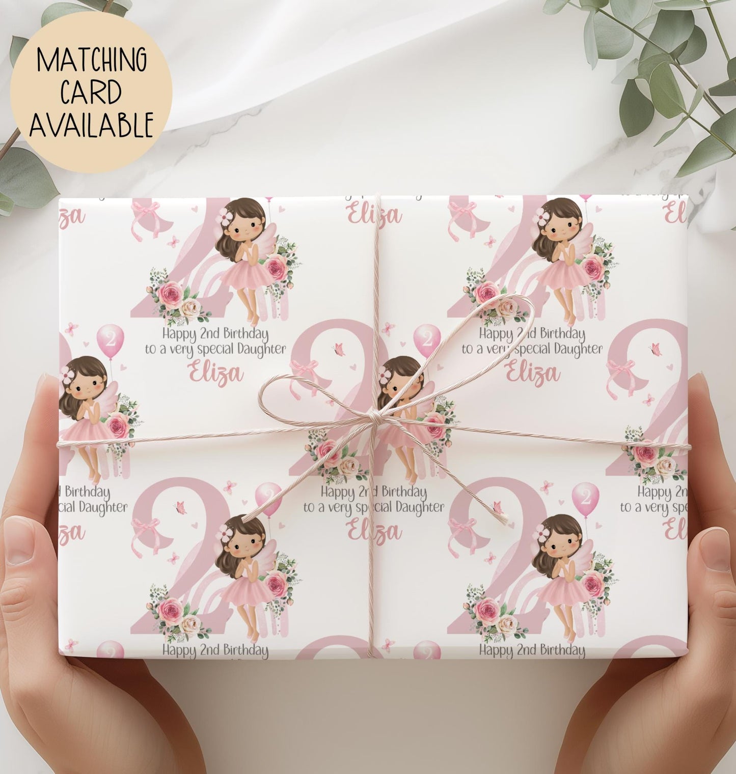 Personalised 2nd birthday gift wrap featuring a cute fairy girl in a pink dress holding a balloon, sitting in front of a pastel rainbow and large pink number one, surrounded by floral accents. Customisable with child’s name and special message, perfect for a granddaughter’s/daughters 1st birthday.