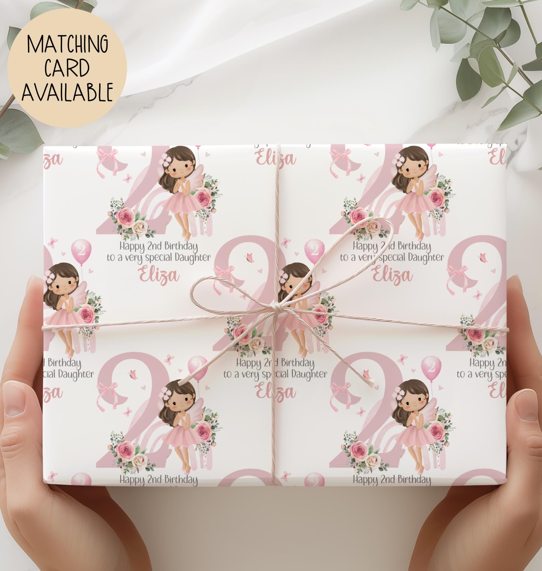 Personalised 2nd birthday gift wrap featuring a cute fairy girl in a pink dress holding a balloon, sitting in front of a pastel rainbow and large pink number one, surrounded by floral accents. Customisable with child’s name and special message, perfect for a granddaughter’s/daughters 1st birthday.
