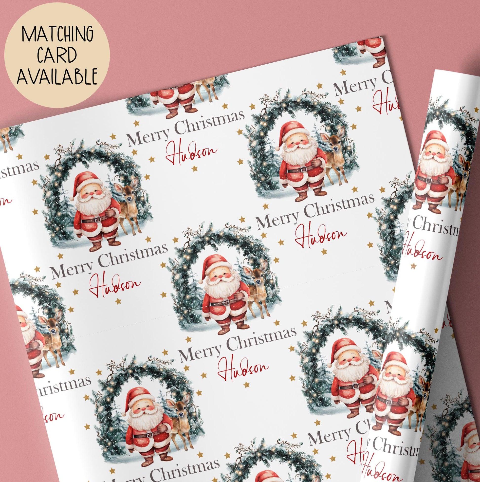 Personalised Christmas giftwrap featuring a leafy green wreath with Christmas lights & Santa & his reindeer & the wording Merry Christmas, personalised with a name.
