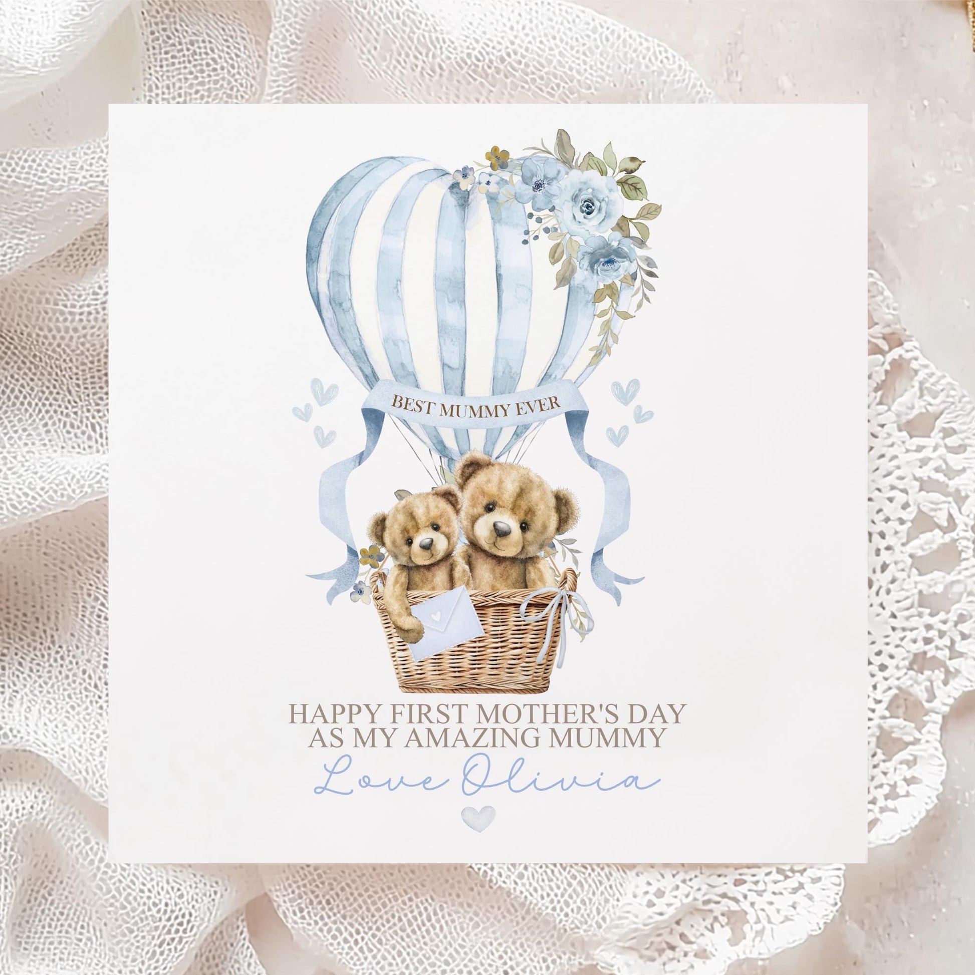 Personalised first Mother’s Day card for new mum, featuring two teddy bears in a wicker basket inside a blue hot air balloon with soft florals and hearts and the wording 'Happy 1st mothers day as my amazing mummy' Personalised with a name.