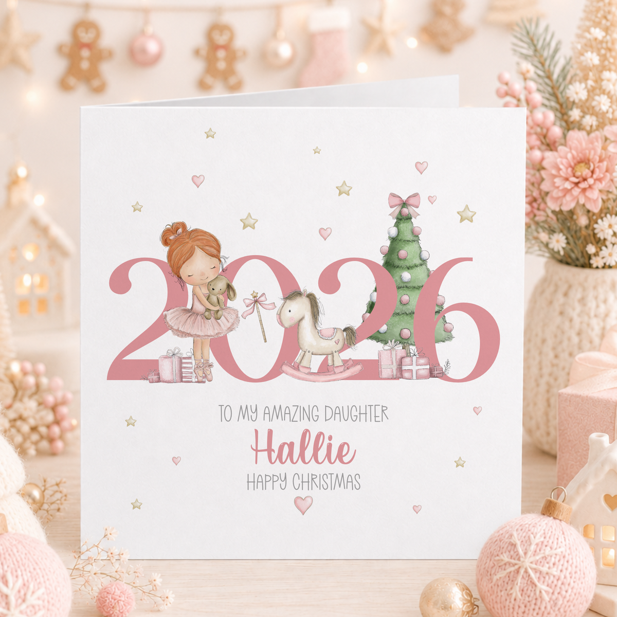 Personalised pink 2026 Christmas card with a red-haired ballerina, rocking horse and Christmas tree, for daughter Hallie.