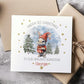 Personalised baby’s 1st Christmas card for Boys & girls featuring a cute bunny in a red hat holding a present, snowy woodland background with fir trees and gold stars. Printed on premium 300gsm card.