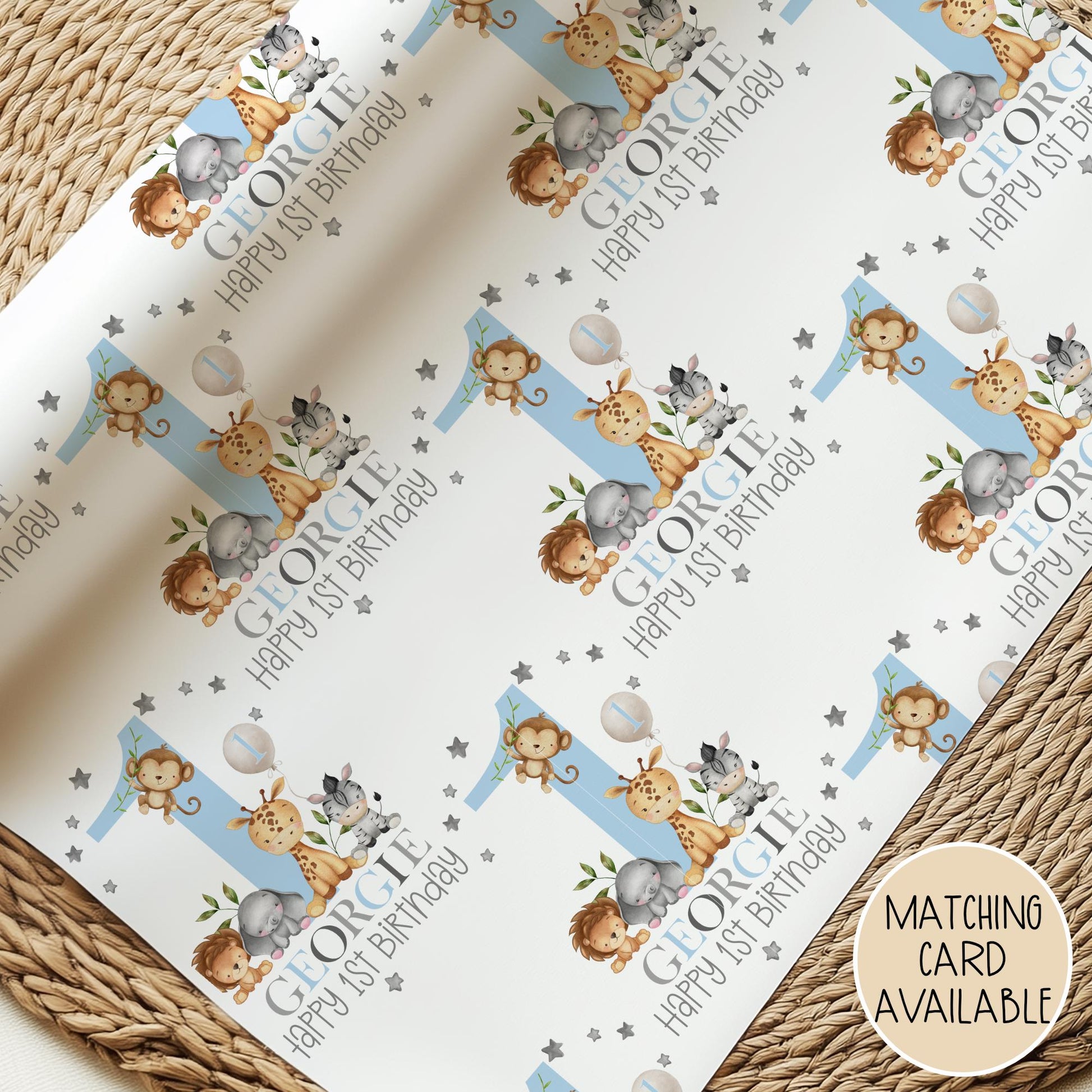 Personalised gift wrap for a 1st birthday featuring a large blue number &#39;1&#39; surrounded by cute safari animals & grey stars. The design includes the text &#39; Happy 1st Birthday&#39; Personalised with a name in multi-coloured text.