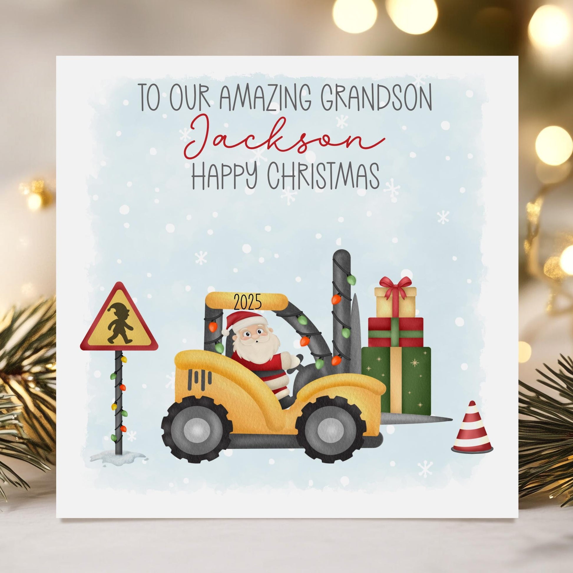 A personalised Christmas card showcasing Santa driving a yellow forklift adorned with festive lights, carrying a stack of presents through a snowy scene with a Christmas-themed road sign. Customise with a name and a cheerful “Happy Christmas” greeting.