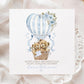 Personalised first Mother’s Day card for new mum, featuring two teddy bears in a wicker basket inside a blue hot air balloon with soft florals and hearts and the wording 'Happy 1st mothers day as my amazing mummy' Personalised with a name.
