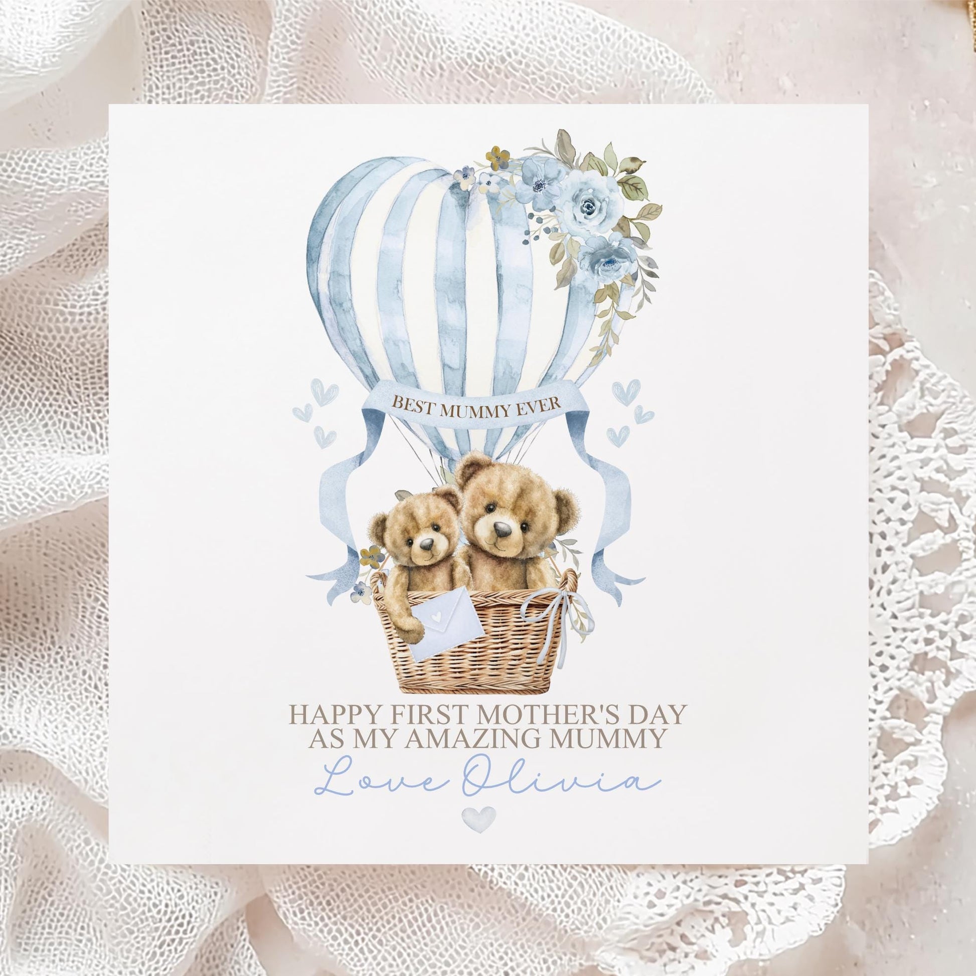Personalised first Mother’s Day card for new mum, featuring two teddy bears in a wicker basket inside a blue hot air balloon with soft florals and hearts and the wording 'Happy 1st mothers day as my amazing mummy' Personalised with a name.