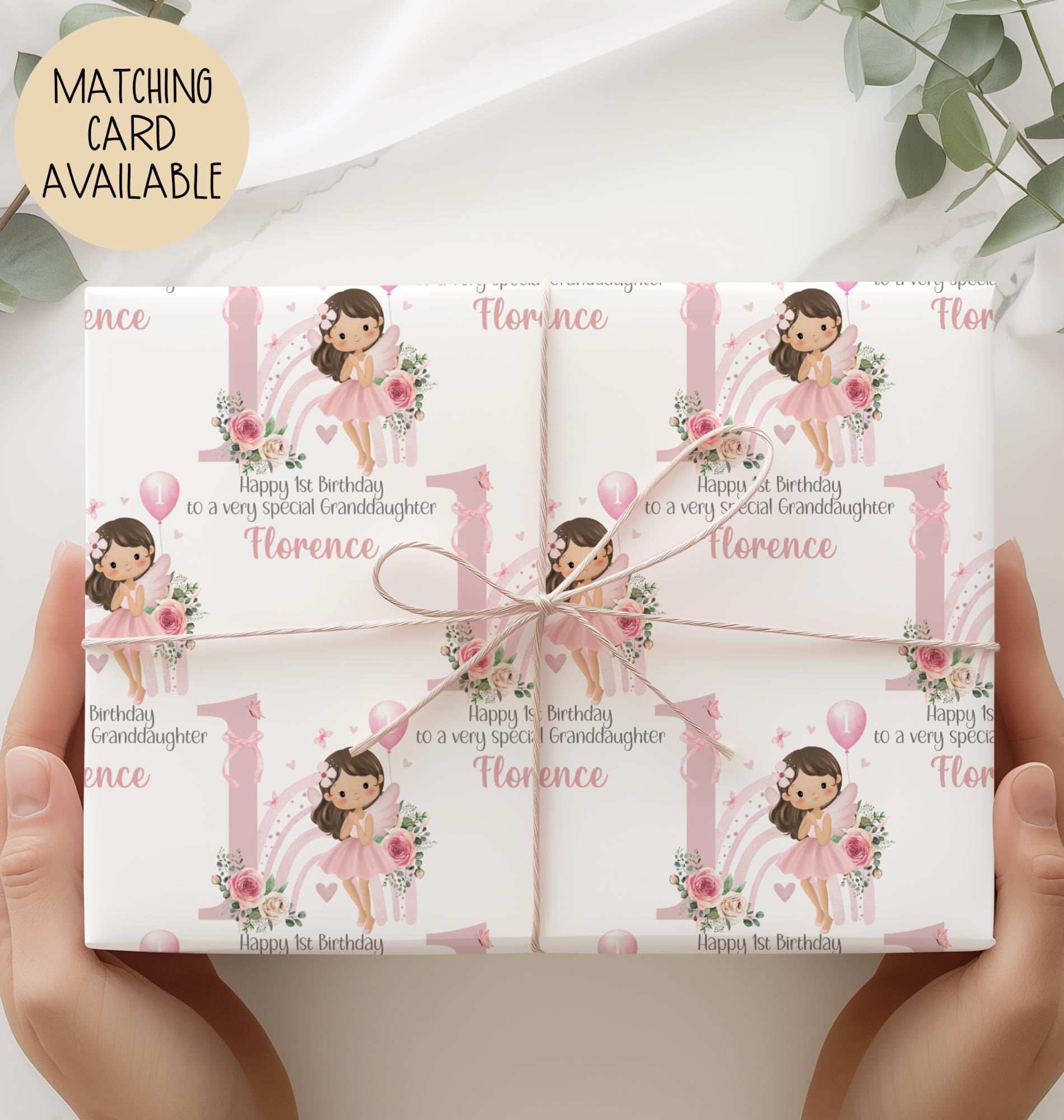 Personalised 1st birthday gift wrap featuring a cute fairy girl in a pink dress holding a balloon, sitting in front of a pastel rainbow and large pink number one, surrounded by floral accents. Customisable with child’s name and special message, perfect for a granddaughter’s/daughters 1st birthday.
