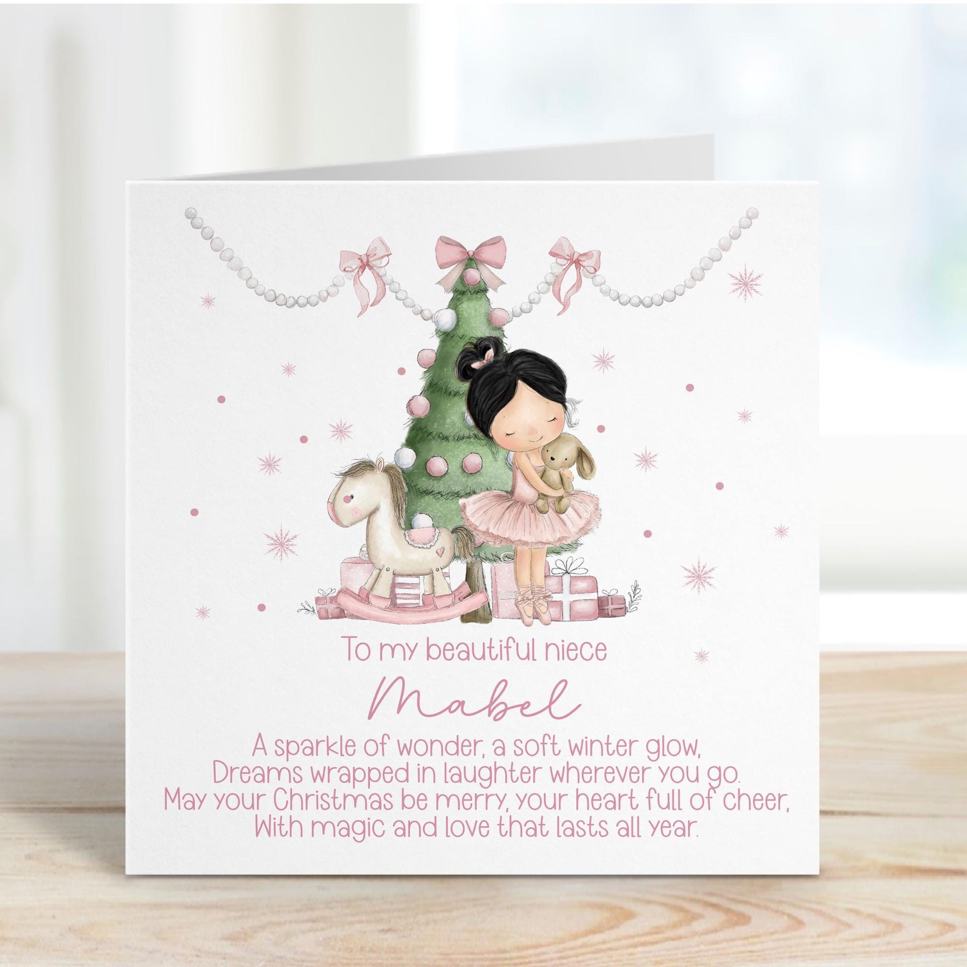 Christmas card with a girl, tree, and pony illustration on a white background, personalised with a name