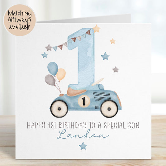 Luxury white linen, lightly textured 1st birthday card featuring a watercolor blue racing car with a number 1 on the side & beige seat & balloons to the back & a watercolor number 1 & a beige, brown & blue bunting & stars & the wording, Happy 1st birthday to a special Grandson/Son/Nephew/wording can be changed to suit. Personalised with the childs name a little star underneath. Card measures 6 x 6 inches.
