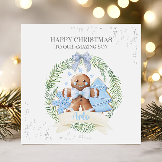 Christmas card with gingerbread man and blue elements on a white background with festive lights and decorations.