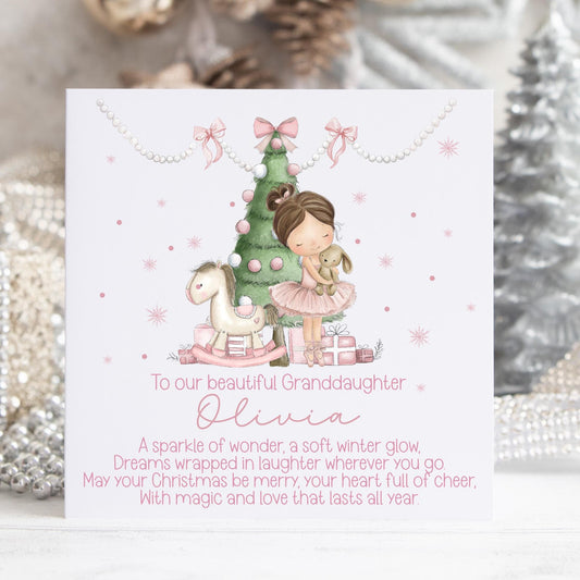Personalised Christmas card featuring a sweet little girl in a pink ballerina dress hugging a soft toy beside a decorated Christmas tree and pink presents. Includes the text “To our beautiful daughter” with space for a personalised name and a festive Christmas poem beneath. Soft pastel colours, winter sparkle details, and a magical holiday theme ideal for daughters.
