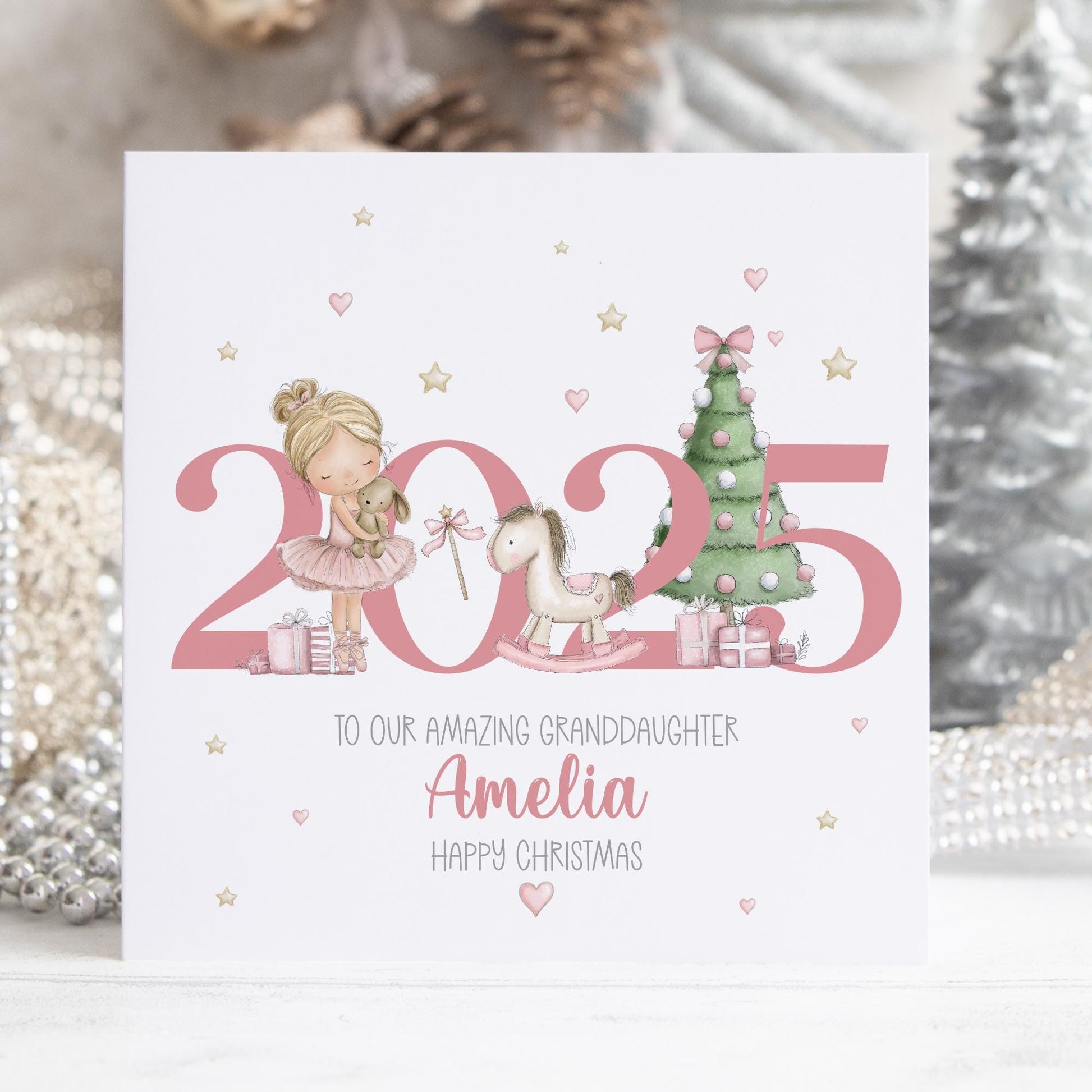 Personalised Christmas card featuring a pink ballerina girl, rocking horse and Christmas tree beside the year 2025 in pastel tones. Perfect for a daughter, granddaughter, niece or little girl.